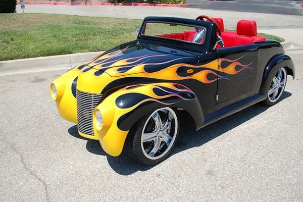 Black 39 Roadster with Yellow Flames affordable golf cart rental, golf cart rent laguna woods golf cart rental