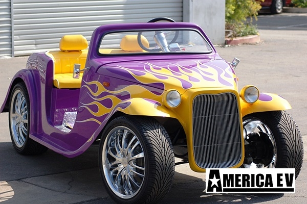 Purple California Roadster with Yellow Flames affordable golf cart rental, golf cart rent laguna woods golf cart rental